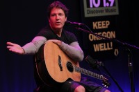 image of lead singer with an acoustic guitar.